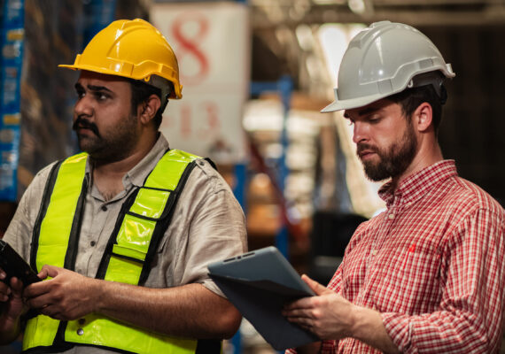 Warehouse worker working and checking the stock in the warehouse. Factory manager using digital tablet check barcode in industry factory logistic.
