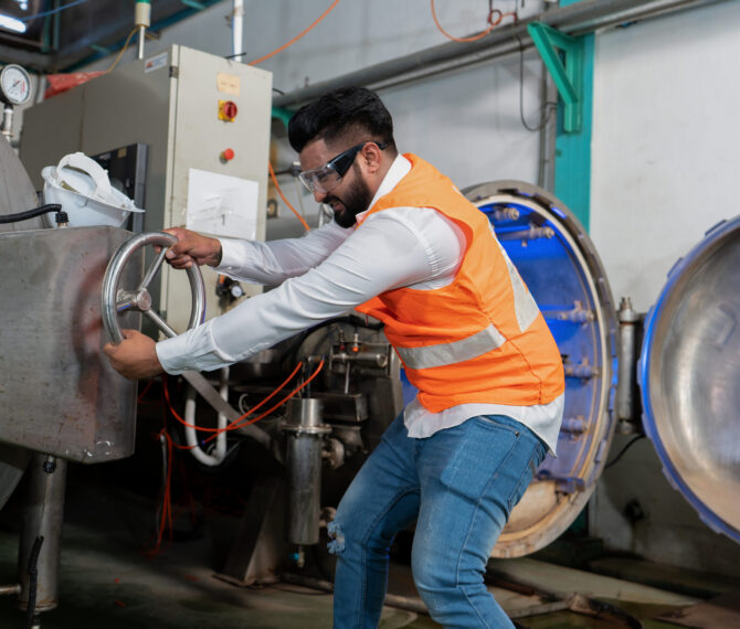 Maintenance engineer tighten hand wheel boiler cover inspection at pressure tank outage shutdown